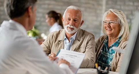 elderly couple at their dental implant consultation 