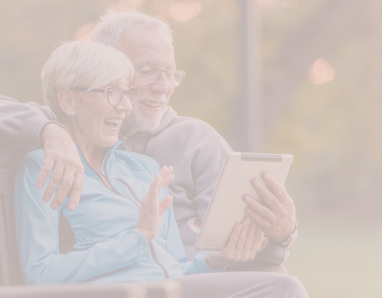 Older couple looking at information about dental services on tablet computer