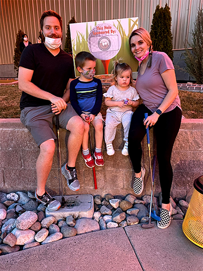 Dental team member and family at mini golf event