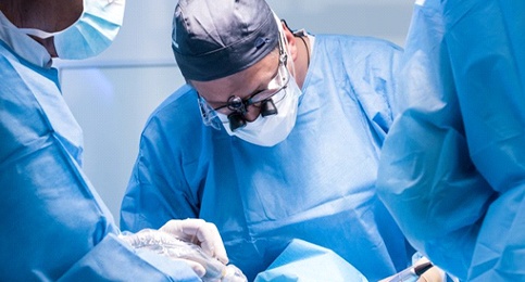 dentists performing dental implant surgery 