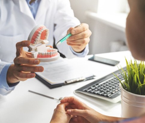 A dentist talking with his patient about direct bonding