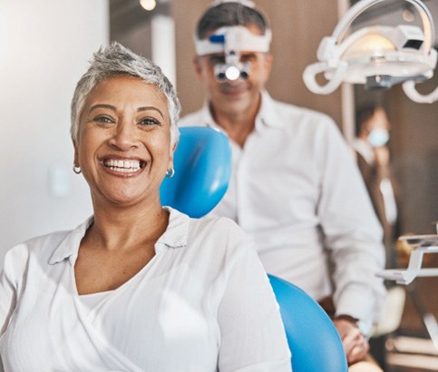 A smiling woman sitting in a dentist’s chair