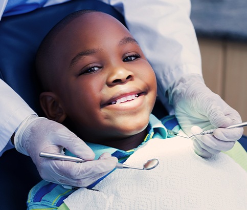 Young boy receiving children's dentistry treatment