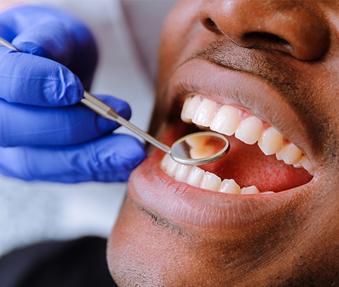 Dentist checking patient's metal free dental restorations