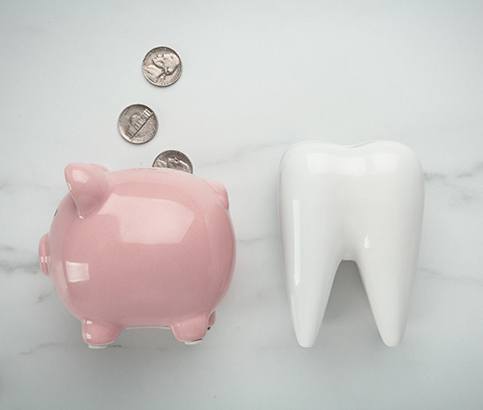 piggy bank and tooth for cost of cosmetic dentistry in Reno    