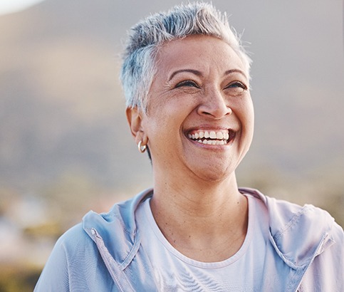 Senior woman with jacket outside and smiling