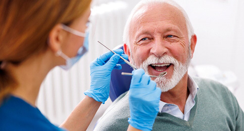 mature man smiling during dental checkup