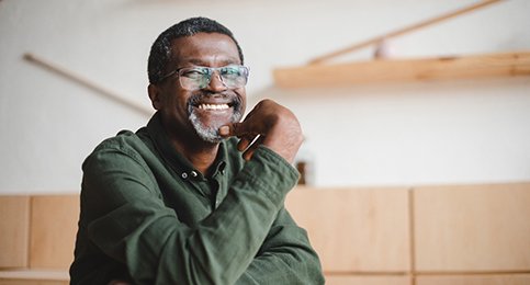 person smiling and sitting at a table