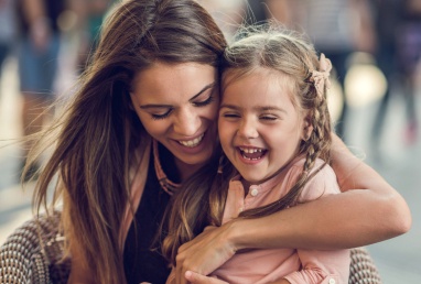 Mother and daughter laughing after dental treatment