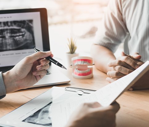 Dentist and patient reviewing dental treatment plan