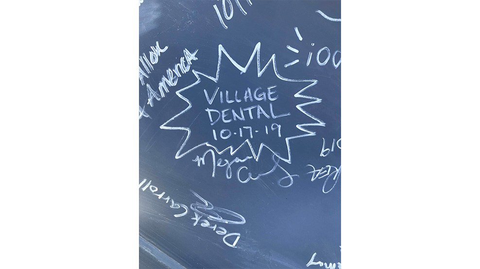 Signatures of team members at dental office grand opening