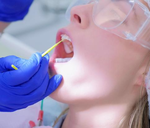 Dental patient receiving fluoride treatment