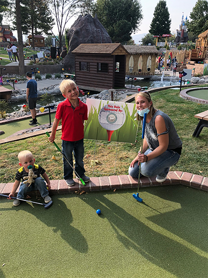 Dental team member and children playing mini golf