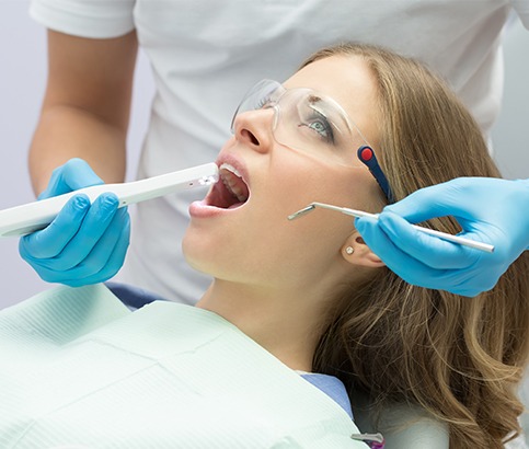 Dentist using intraoral camera to capture images