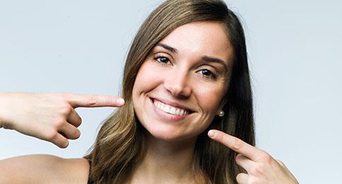 Woman pointing at her teeth