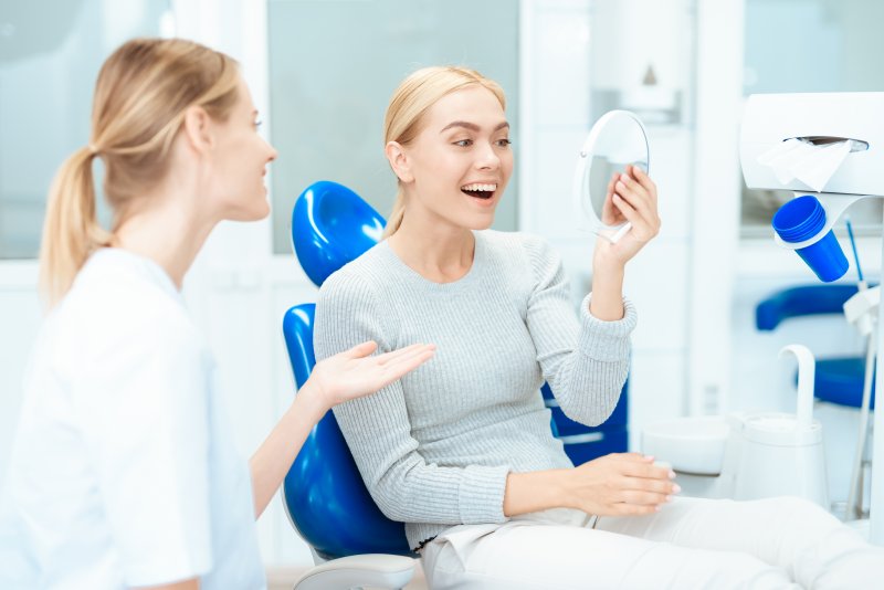 A woman meeting with a cosmetic dentist