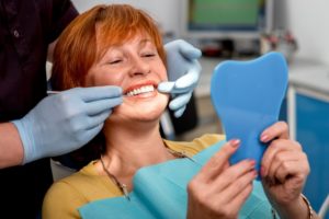 a woman smiling confidently with her dental implants